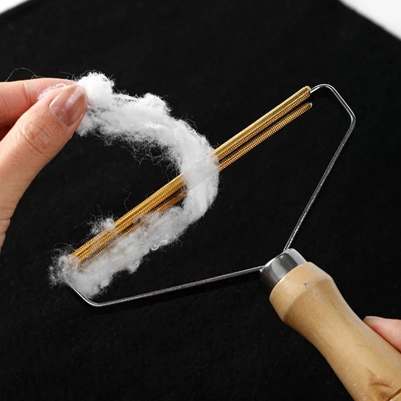 Pet hair remover tool cleaning loose fur from a sofa