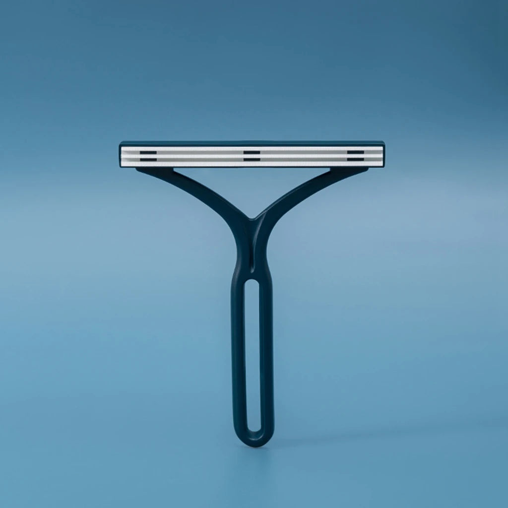 Manual pet lint brush for removing fur from fabric surfaces